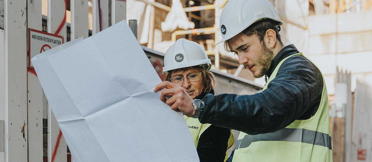 Twee studenten werforganisatie aan HOGENT bekijken een digitaal bouwplan.